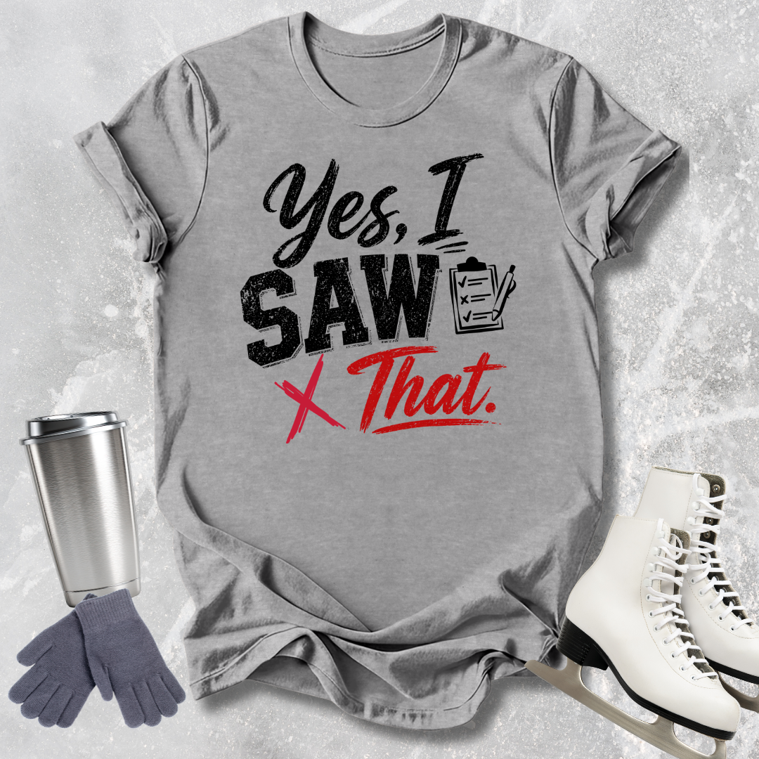 Gray t-shirt with humorous text design, placed on a textured surface with a tumbler, gloves, and skates.