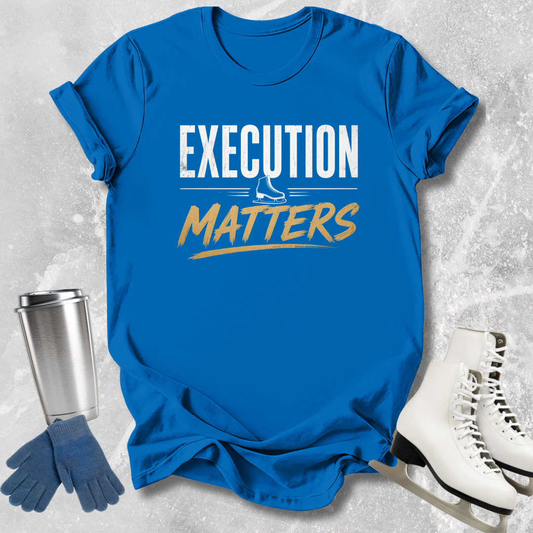 Blue t-shirt with 'EXECUTION MATTERS' text, silver tumbler, blue gloves, and white skates on a textured gray background
