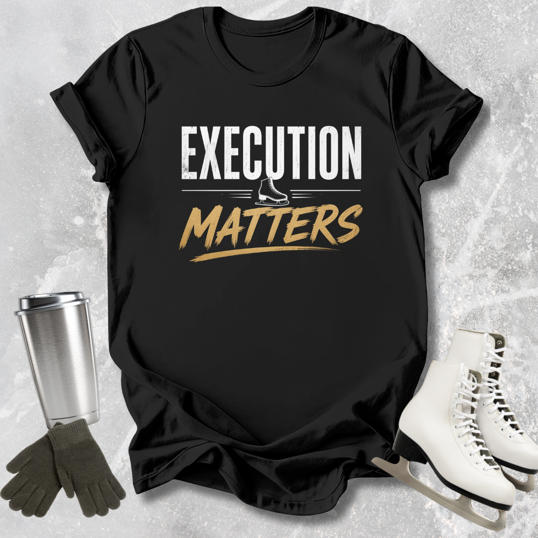 Black t-shirt with 'Execution Matters' text on a textured surface with accessories.