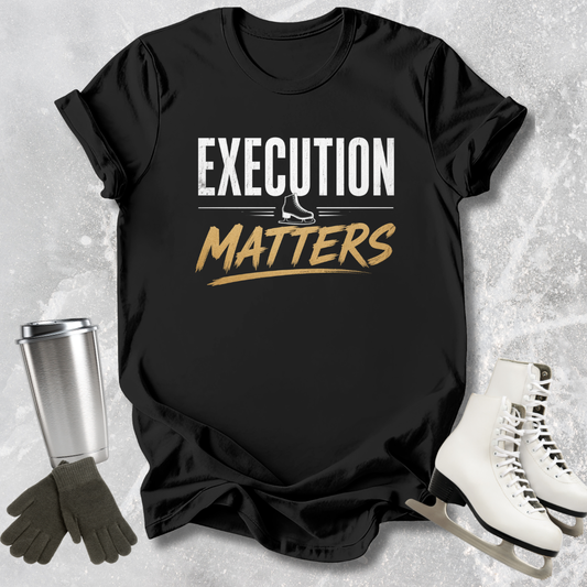 Black t-shirt with 'Execution Matters' text on a textured surface with accessories.
