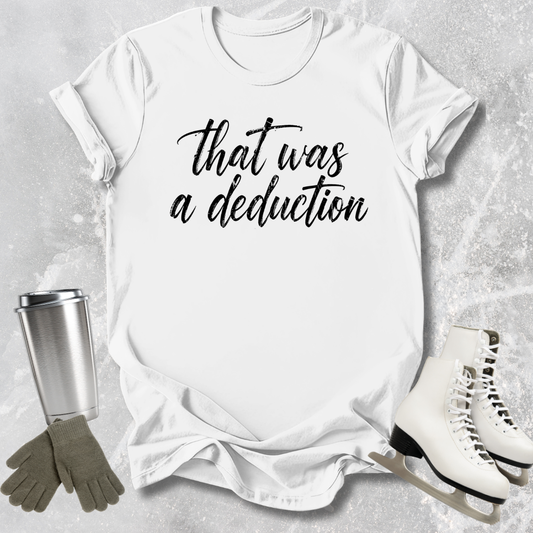 White t-shirt with 'That was a deduction' text, next to a silver tumbler, green gloves, and white skates on a gray textured background.