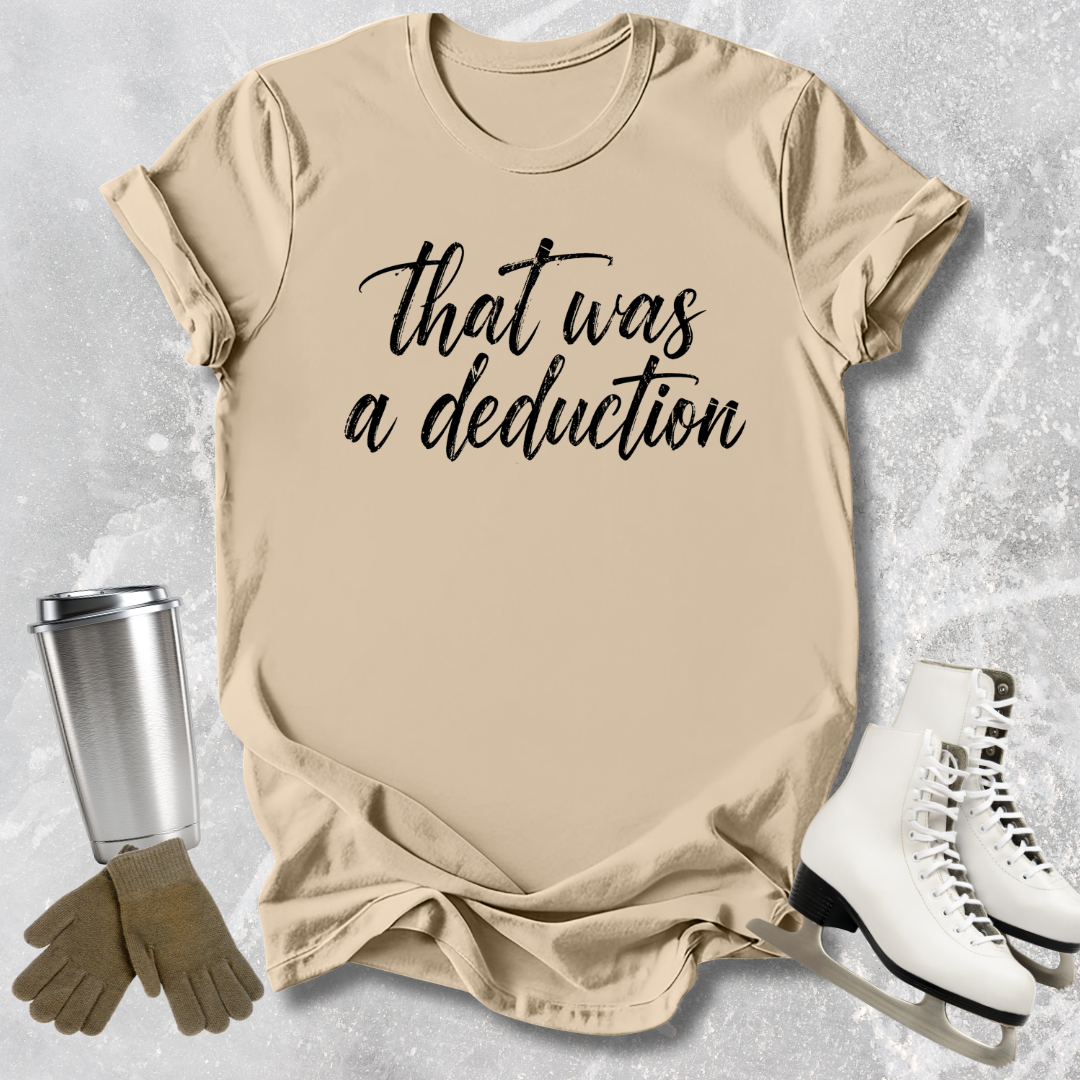 Beige t-shirt with 'that was a deduction' text, next to a silver tumbler, brown gloves, and white skates on a light gray background.