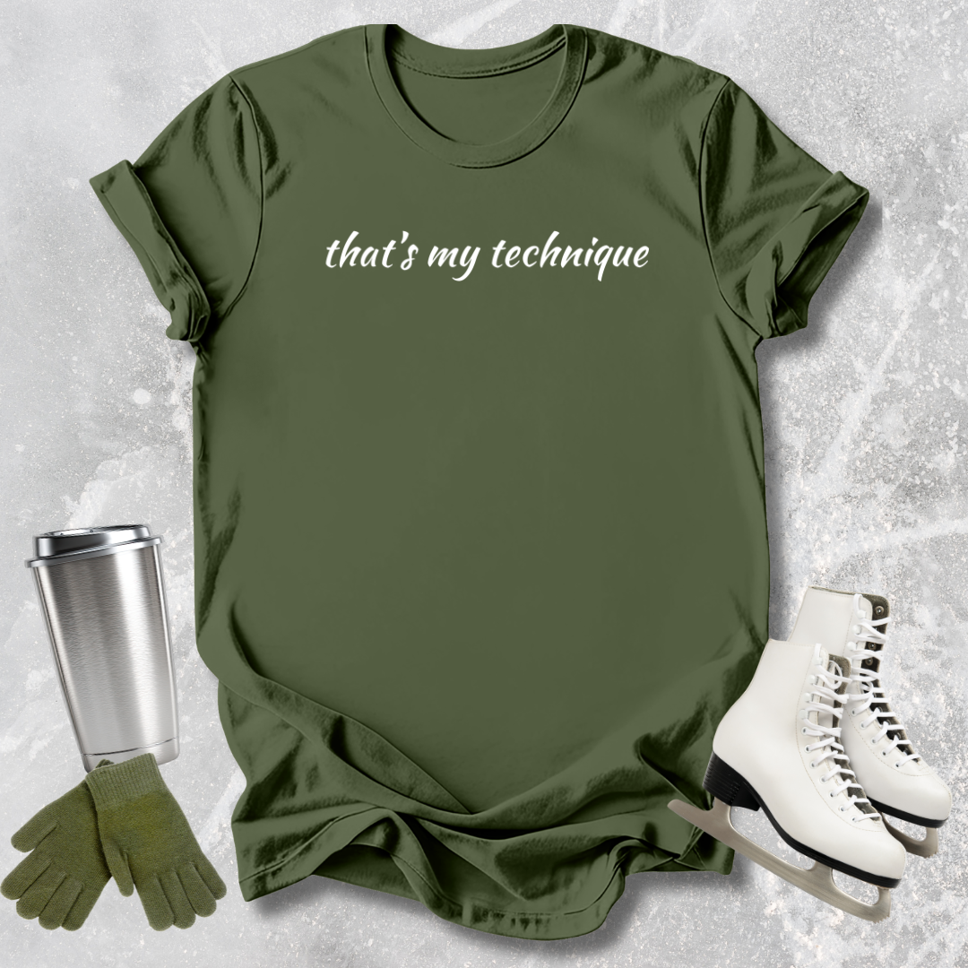 Green t-shirt with 'that's my technique' text, silver tumbler, green gloves, and white high-top sneakers on a textured surface.