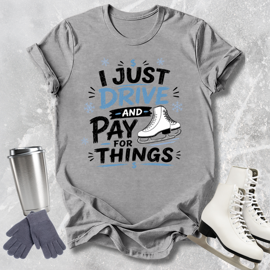 Gray t-shirt with humorous text design, surrounded by ice skates, gloves, and a tumbler on a textured surface.