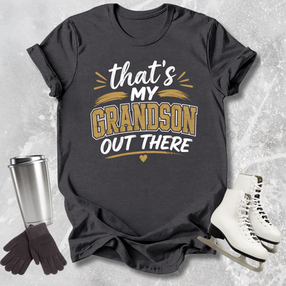 Black t-shirt with 'That's my grandson out there' text, next to a silver tumbler, black gloves, and white skates on a textured gray background.