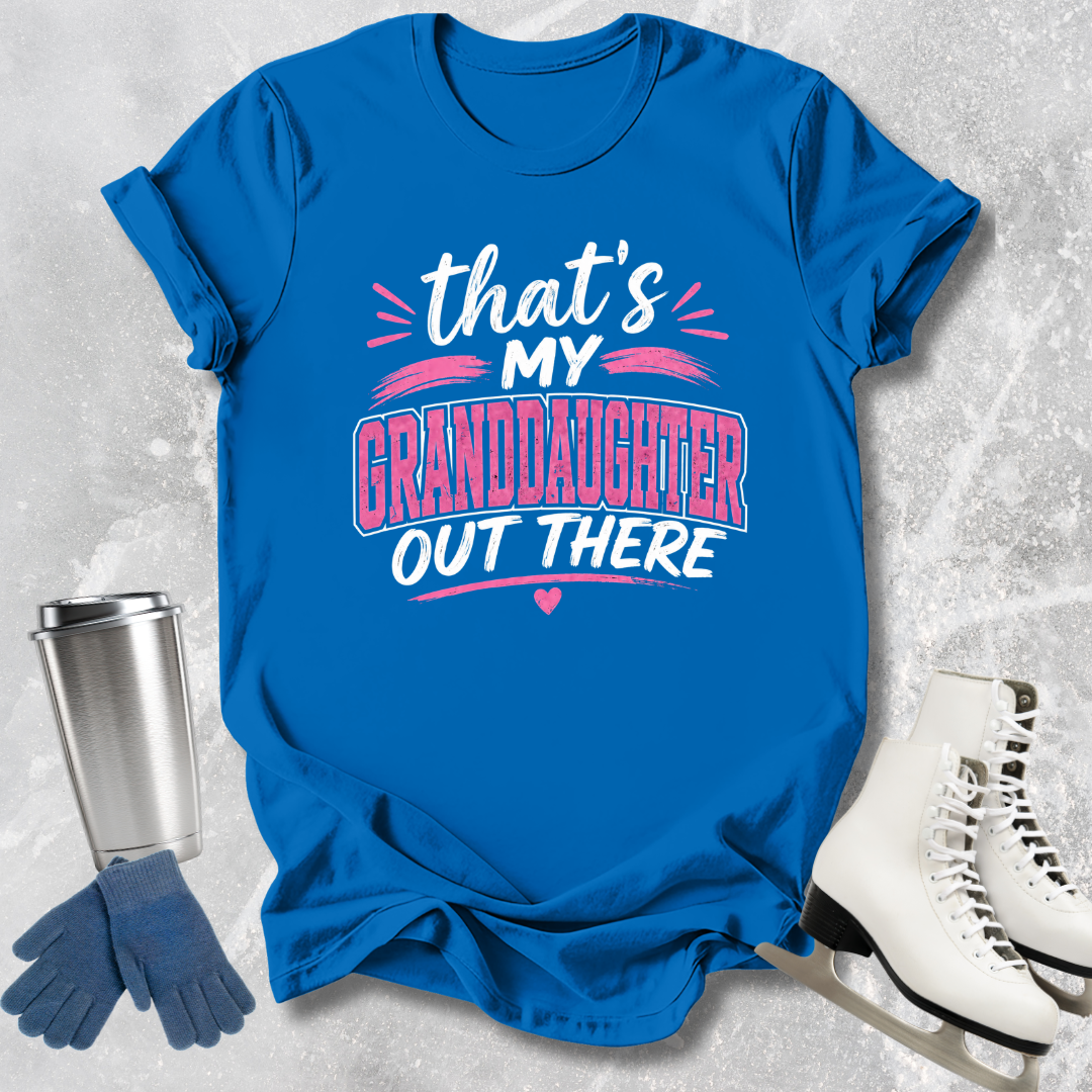 Blue t-shirt with text 'That's my granddaughter out there' on a textured surface with accessories.