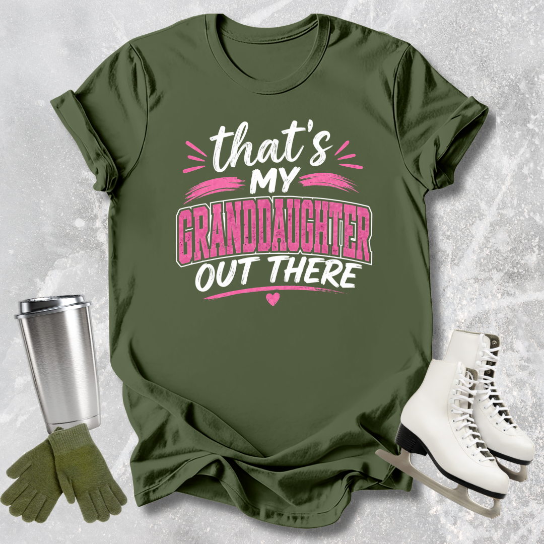 Green t-shirt with text 'That's my granddaughter out there' on a textured surface with accessories.