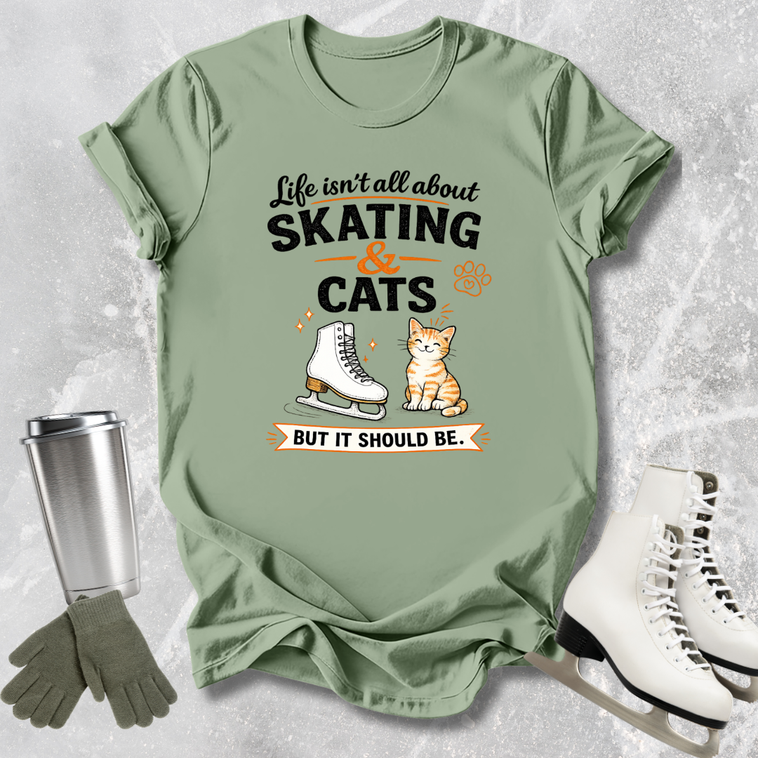 Green t-shirt with skating and cats graphic and accessories on a textured surface