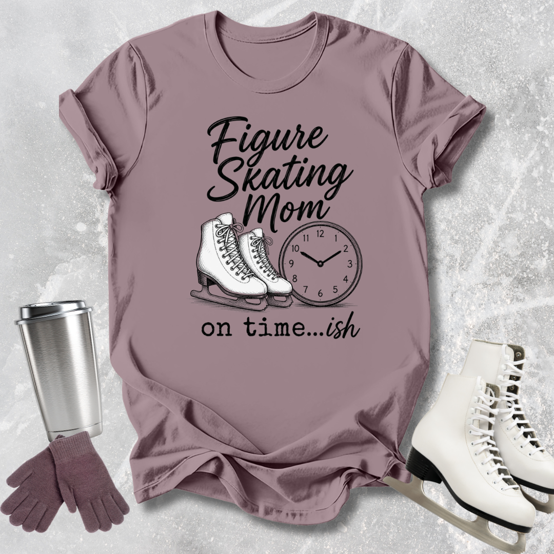 Mauve t-shirt with figure skating design, ice skates, gloves, and a cup on a textured background