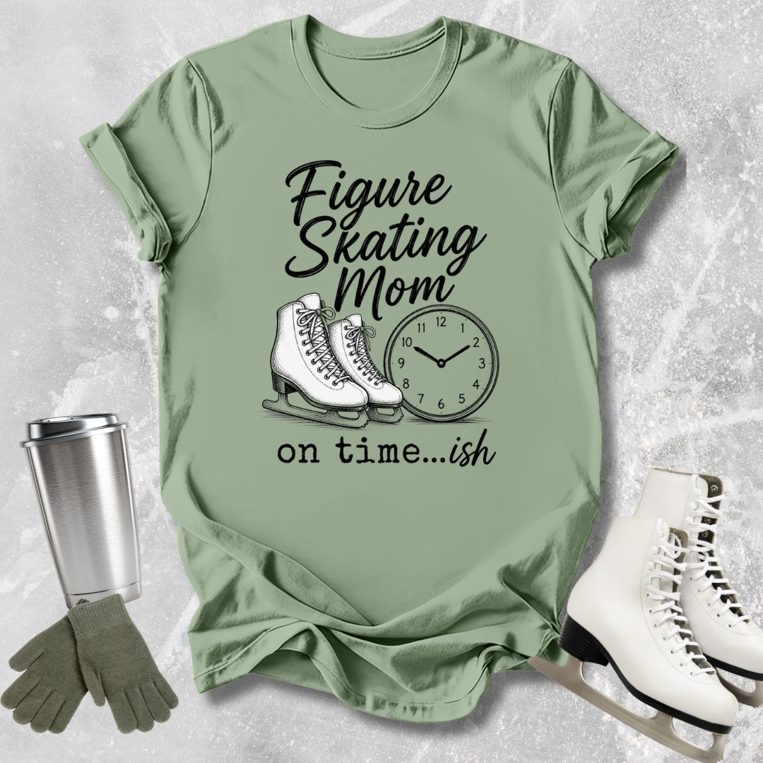 Green t-shirt with figure skating mom graphic and accessories on a textured surface