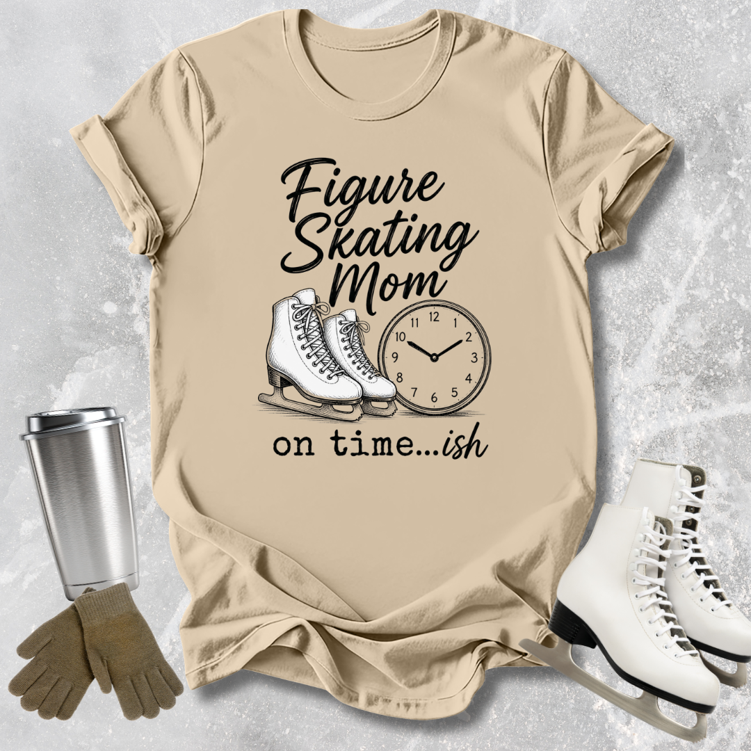 Beige t-shirt with figure skating mom graphic and accessories on a textured surface