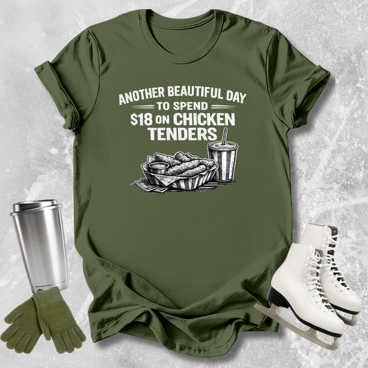 Green t-shirt with graphic and text on a textured surface with accessories.