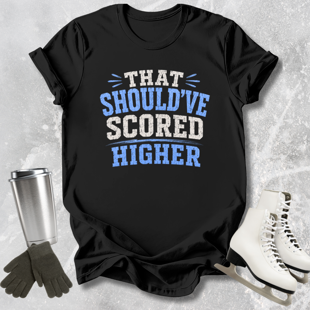 Black t-shirt with 'THAT SHOULD'VE SCORED HIGHER' text on a textured surface with accessories.