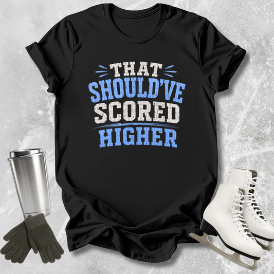 Black t-shirt with 'THAT SHOULD'VE SCORED HIGHER' text on a textured surface with accessories.