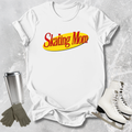 White t-shirt with 'Skating Mom' text, silver tumbler, gray gloves, and white skates on a textured gray background