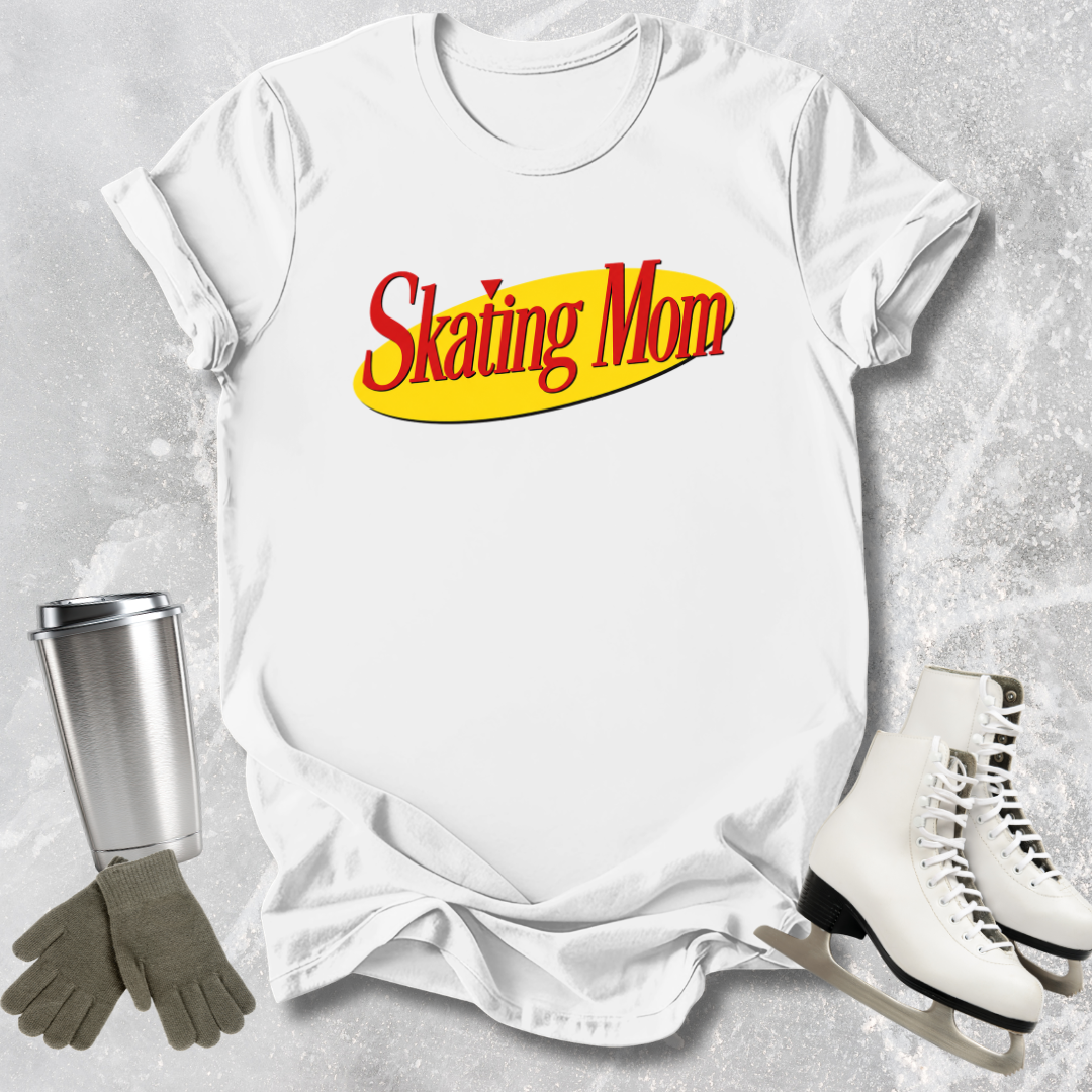 White t-shirt with 'Skating Mom' text, silver tumbler, gray gloves, and white skates on a textured gray background