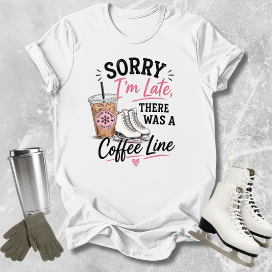 White t-shirt with humorous text design featuring a coffee cup and skates, placed on a textured surface with accessories.