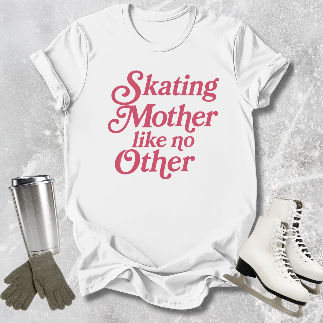 White t-shirt with pink text 'Skating Mother like no Other', next to ice skates, gloves, and a tumbler on a textured gray background.