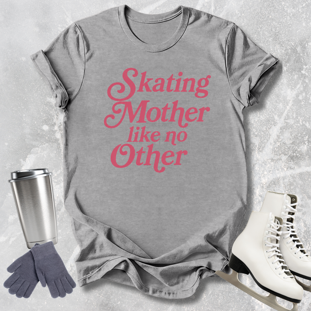 Gray t-shirt with pink text 'Skating Mother like no Other' on a textured gray background with a tumbler, gloves, and skates.