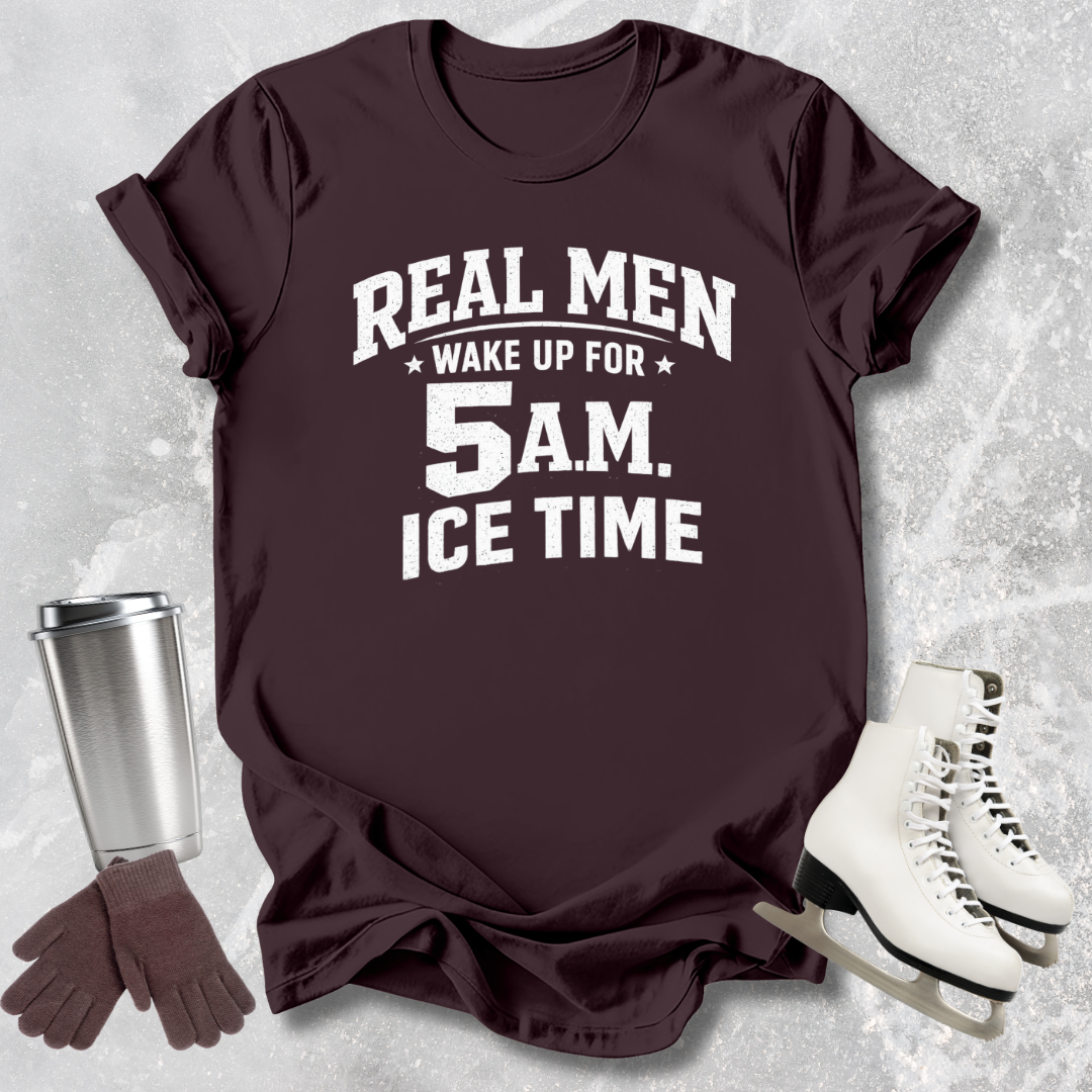 Maroon t-shirt with text 'Real men wake up for 5 A.M. Ice time' on a textured gray background with accessories.