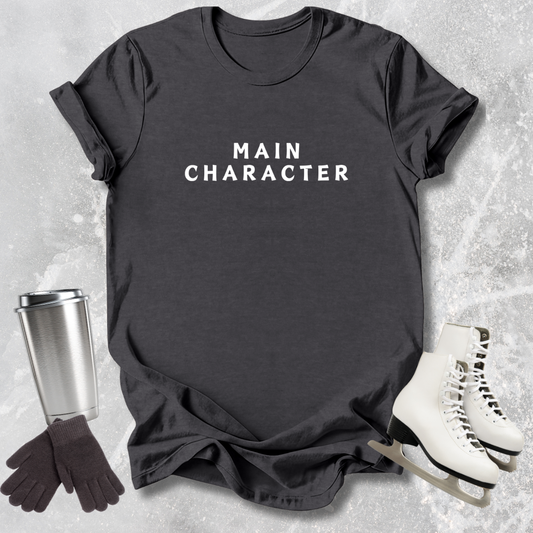 Dark gray t-shirt with 'that's my technique' text, next to a silver tumbler, black gloves, and white skates on a textured surface.