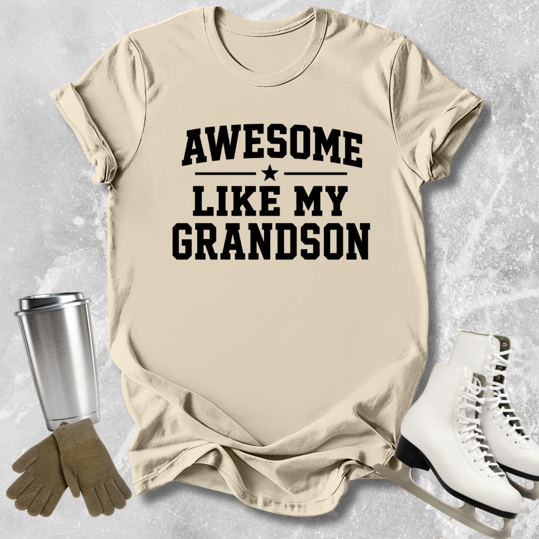 Beige t-shirt with 'Awesome Like My Grandson' text on a textured surface with accessories.