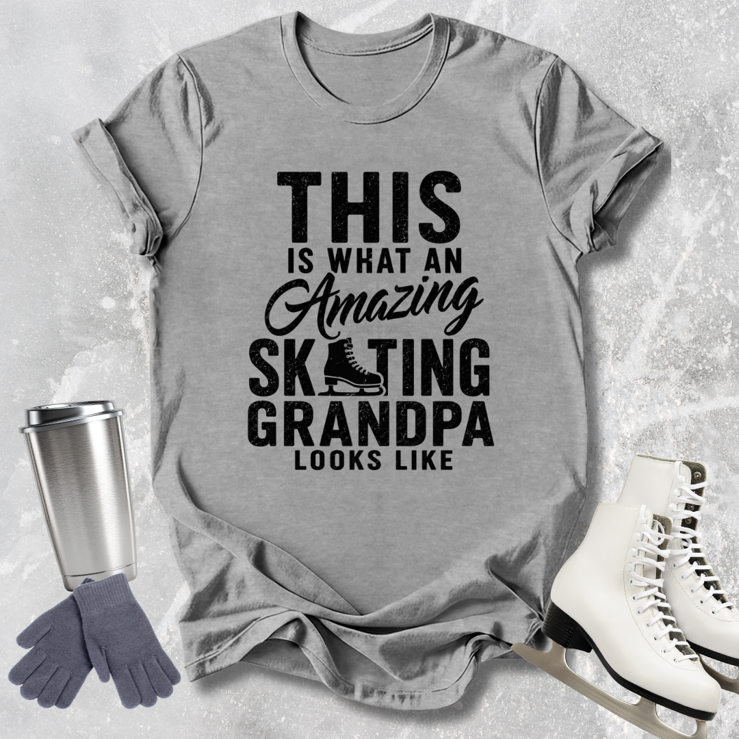 Gray t-shirt with text 'This is what an amazing skating grandpa looks like' on a textured surface with accessories.