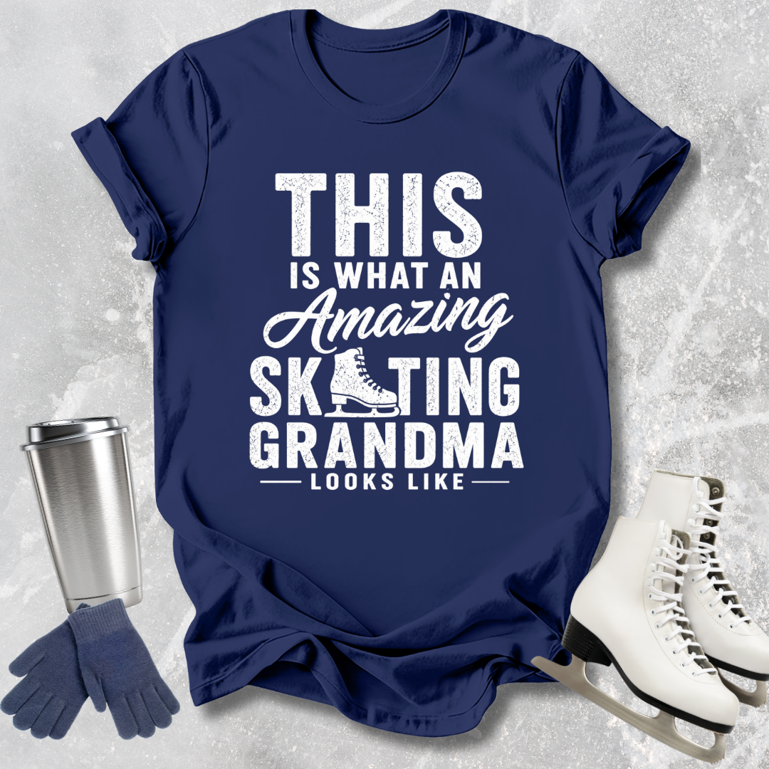Navy blue t-shirt with white text 'This is what an amazing skating grandma looks like' on a textured gray background.