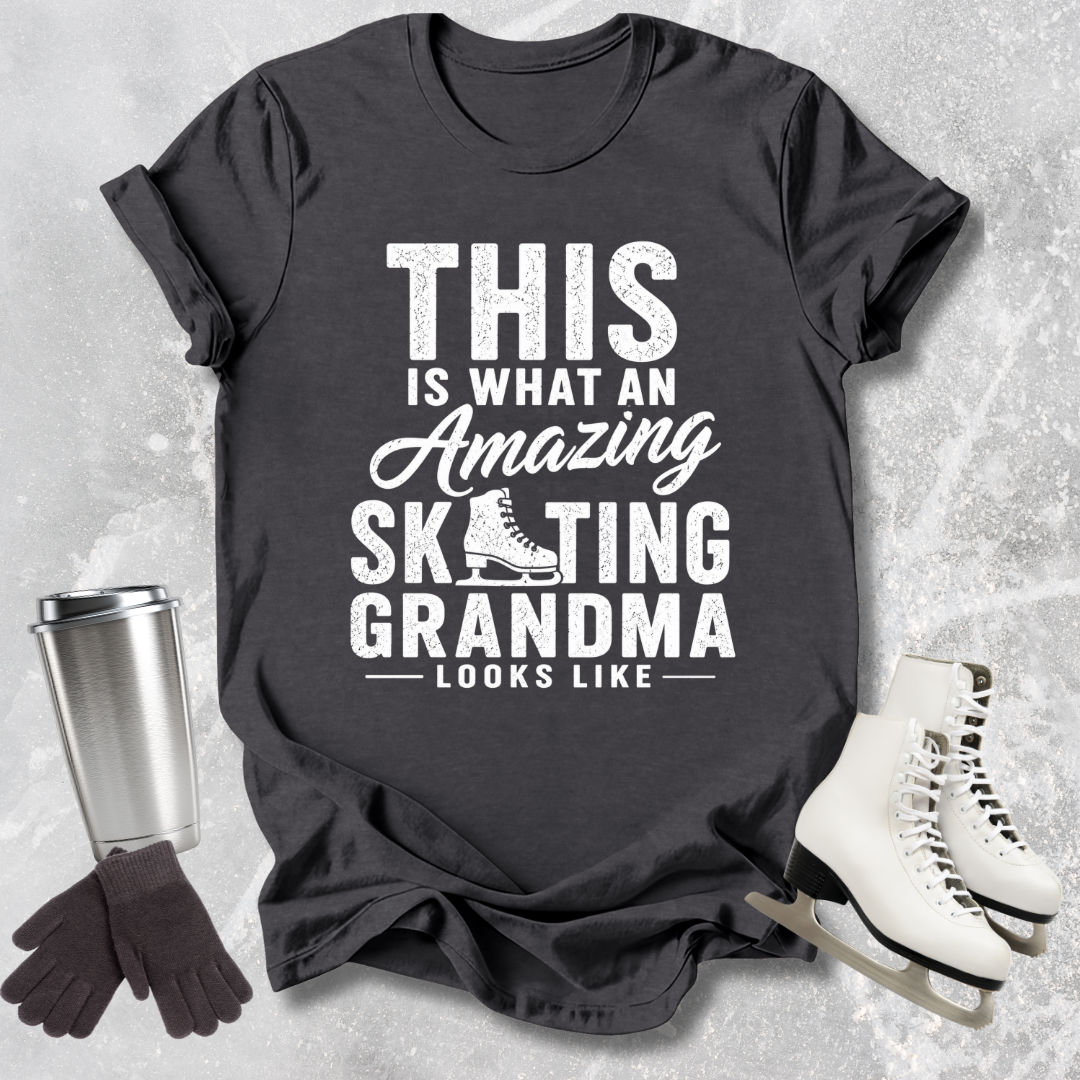 Black t-shirt with 'Amazing Skating Grandma' text on a textured surface with ice skates and gloves.