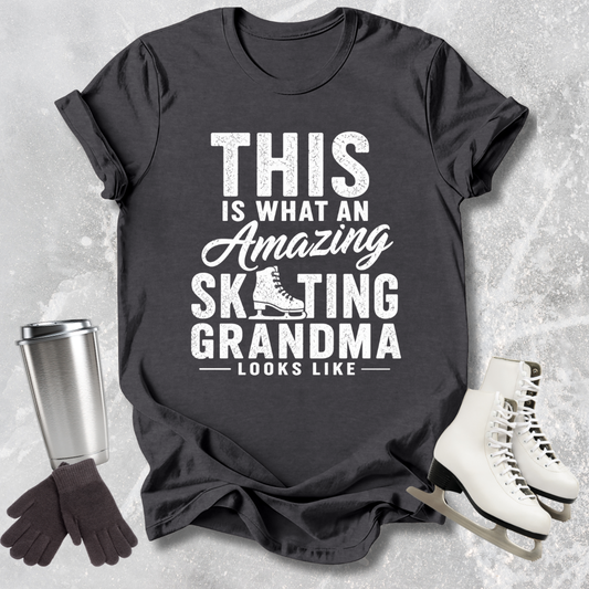 Black t-shirt with 'Amazing Skating Grandma' text on a textured surface with ice skates and gloves.
