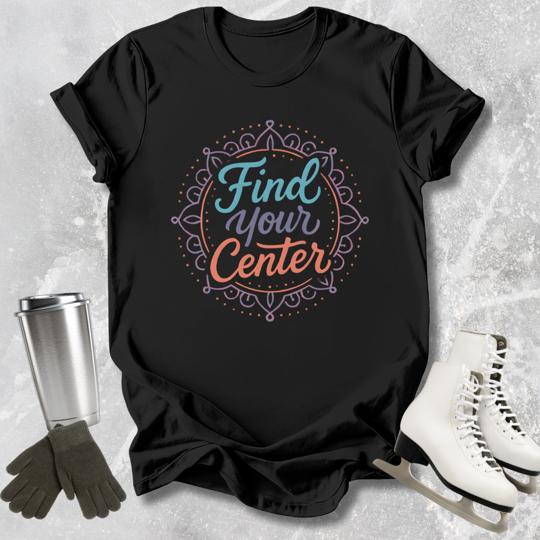 Black t-shirt with 'Find Your Center' design on a textured surface with accessories.