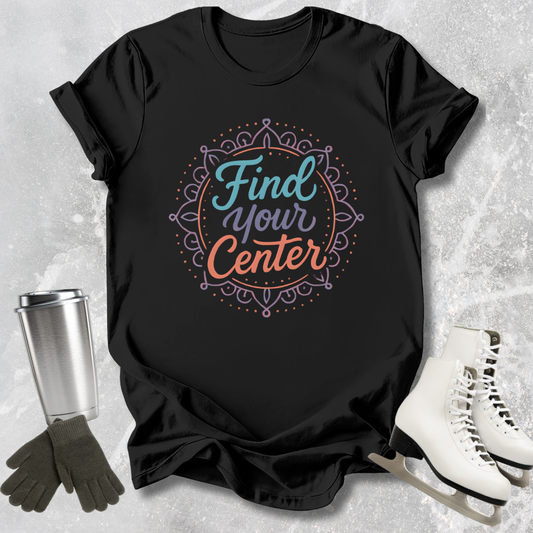 Black t-shirt with 'Find Your Center' design on a textured surface with accessories.
