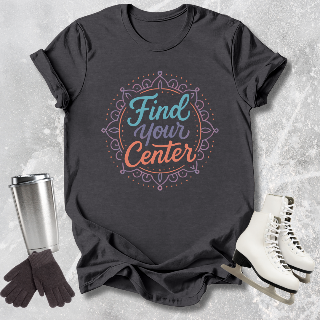 Black t-shirt with 'Find Your Center' design, surrounded by a travel mug, gloves, and skates on a textured surface.