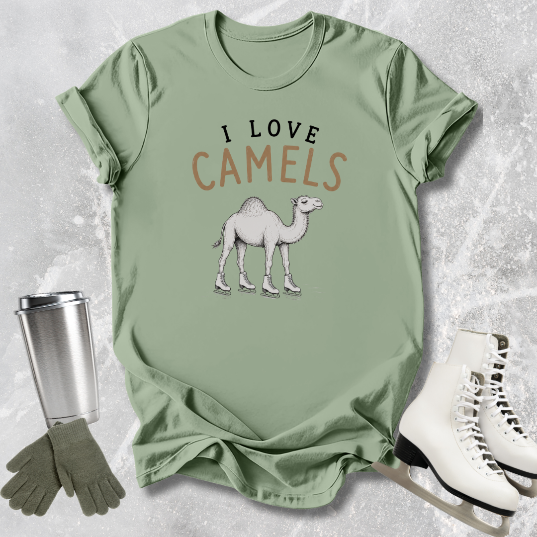 Green t-shirt with 'I Love Camels' design, next to a silver tumbler, green gloves, and white shoes on a textured surface.