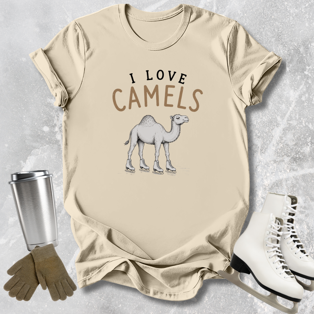 Beige t-shirt with 'I Love Camels' text and camel graphic, next to a silver tumbler, brown gloves, and white shoes on a textured surface.