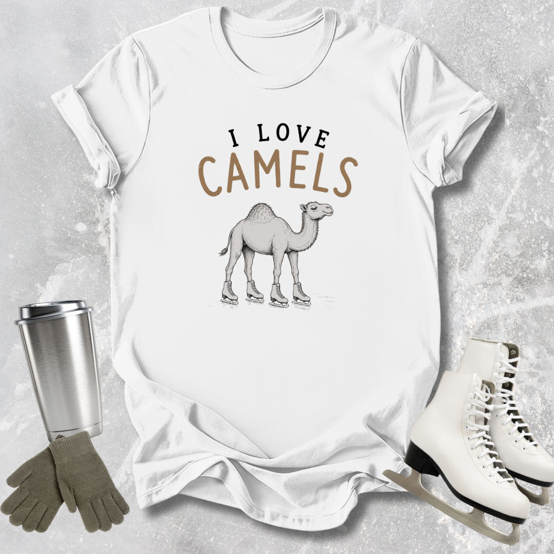 White t-shirt with 'I Love Camels' graphic, surrounded by a tumbler, gloves, and ice skates on a textured surface.