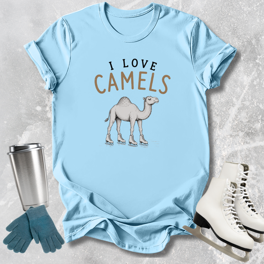 Light blue t-shirt with 'I Love Camels' text and camel graphic, next to a silver tumbler, green gloves, and white skates on a textured surface.