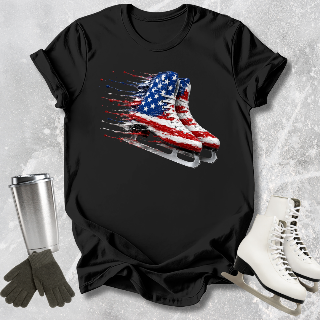Black t-shirt with American flag ice skate design, placed on a textured surface with ice skates and gloves.
