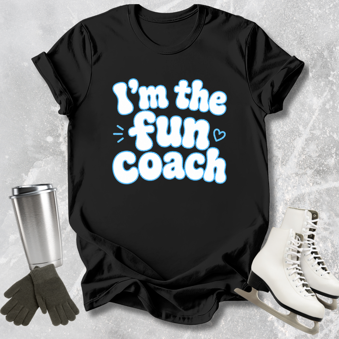 Black t-shirt with 'I'm the fun coach' text on a textured surface with accessories.