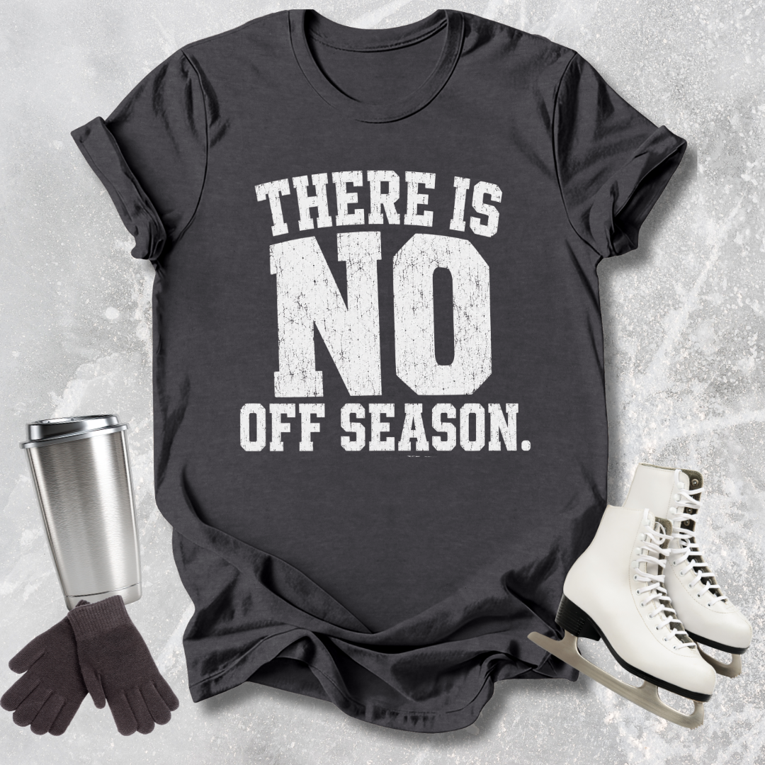 Black t-shirt with 'There is no off season' text, next to ice skates and a travel mug on a textured surface.
