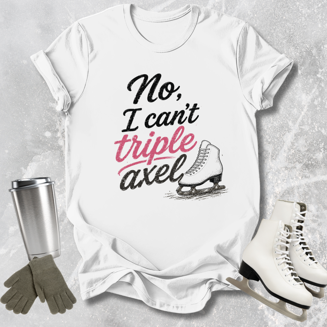 White t-shirt with 'No, I can't triple Axel' text, ice skates, gloves, and a tumbler on a textured surface.