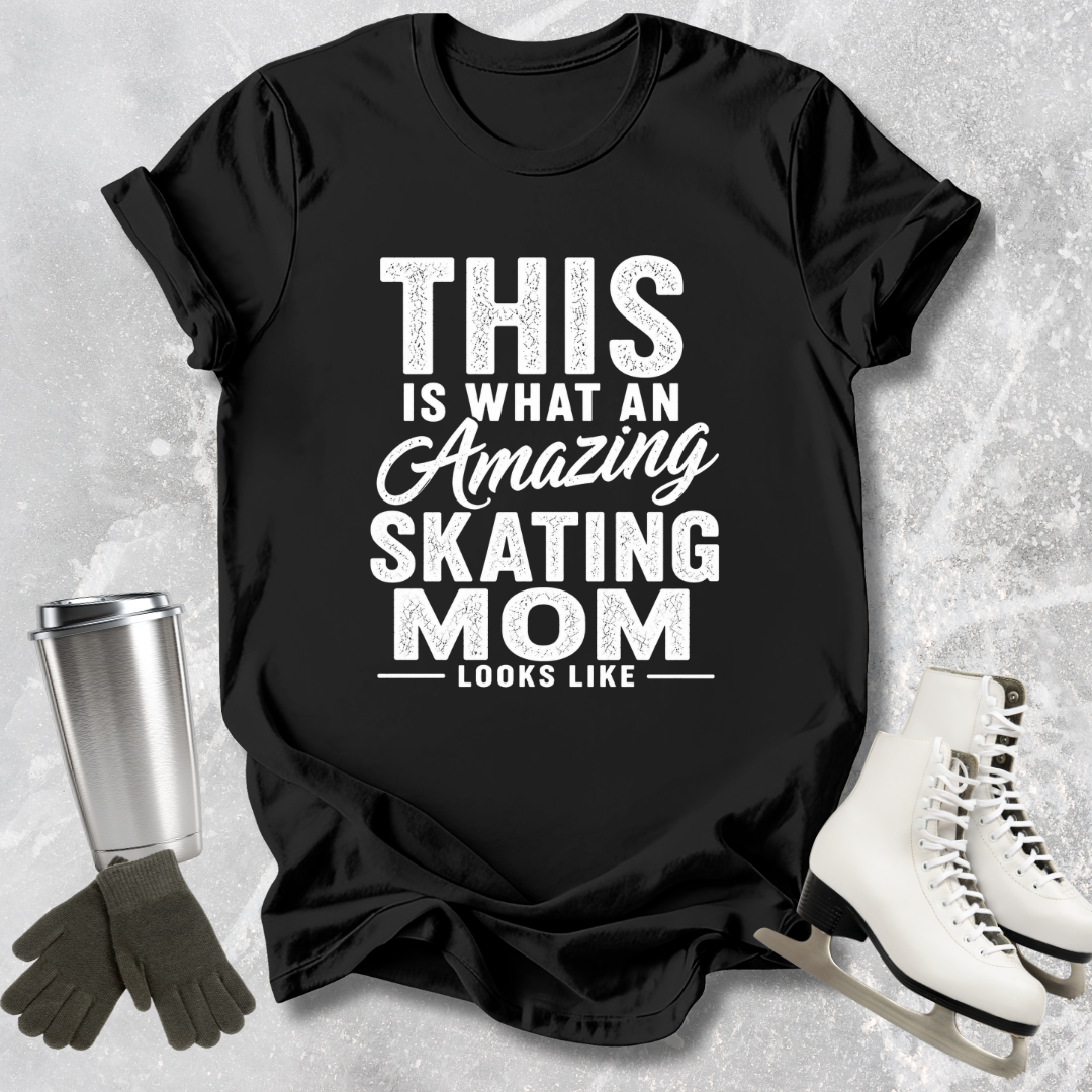 Black t-shirt with 'Amazing Skating Mom' text on a textured surface with ice skates and gloves.