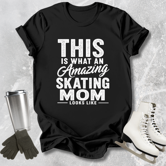 Black t-shirt with 'Amazing Skating Mom' text on a textured surface with ice skates and gloves.