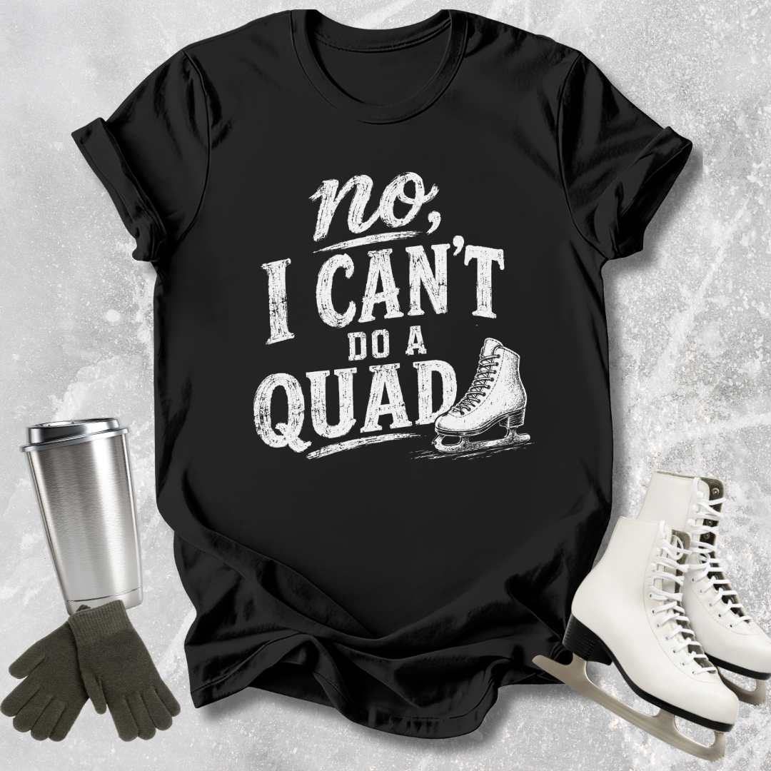 Black t-shirt with 'no, I can't do a quad' text and ice skate graphic on a textured gray background.