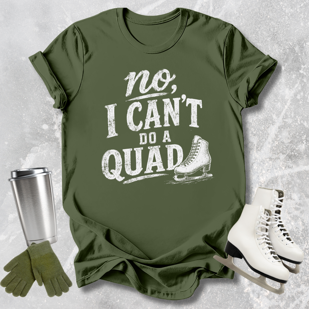 Grren t-shirt with 'no, I can't do a quad' text and ice skate graphic on a textured gray background.