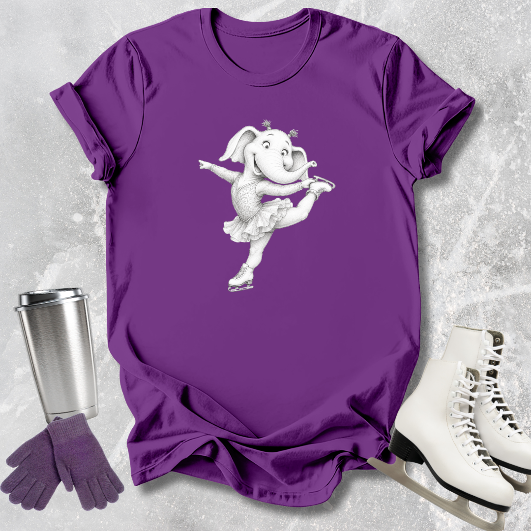 Purple t-shirt with a cartoon elephant design, next to a silver tumbler, purple gloves, and white ice skates on a textured gray background.
