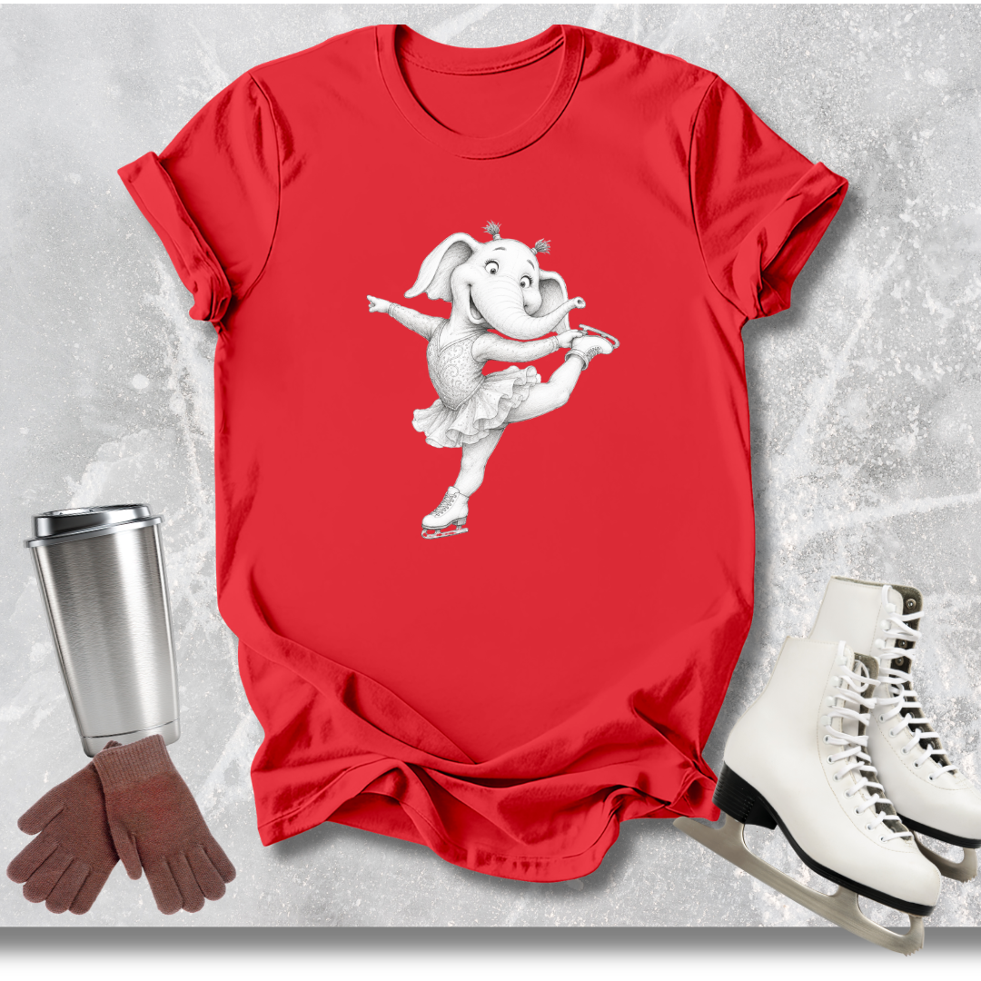 Red t-shirt with a cartoon elephant design, next to a silver tumbler, brown gloves, and white ice skates on a textured gray background.