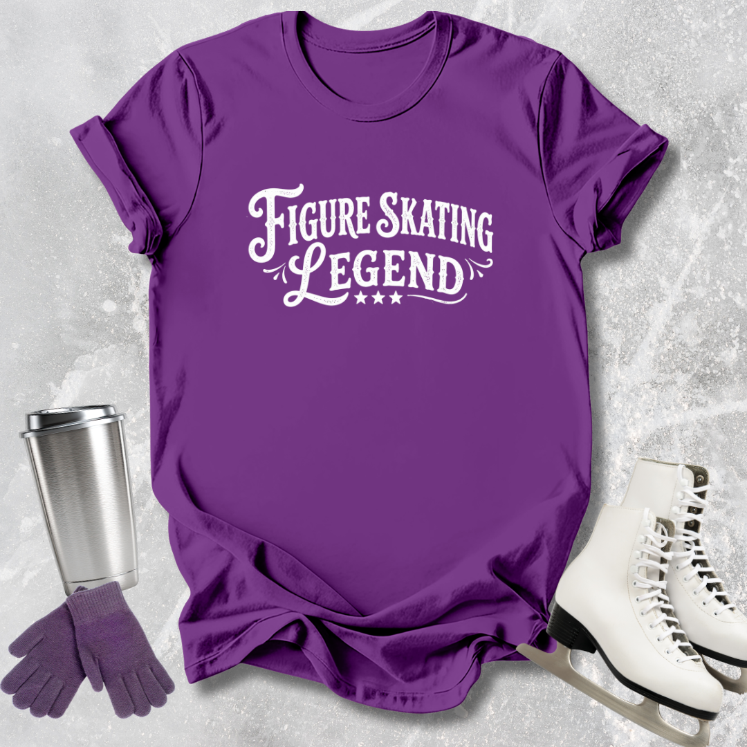 Purple t-shirt with 'Figure Skating Legend' text, next to a silver tumbler, purple gloves, and white skates on a textured gray background.