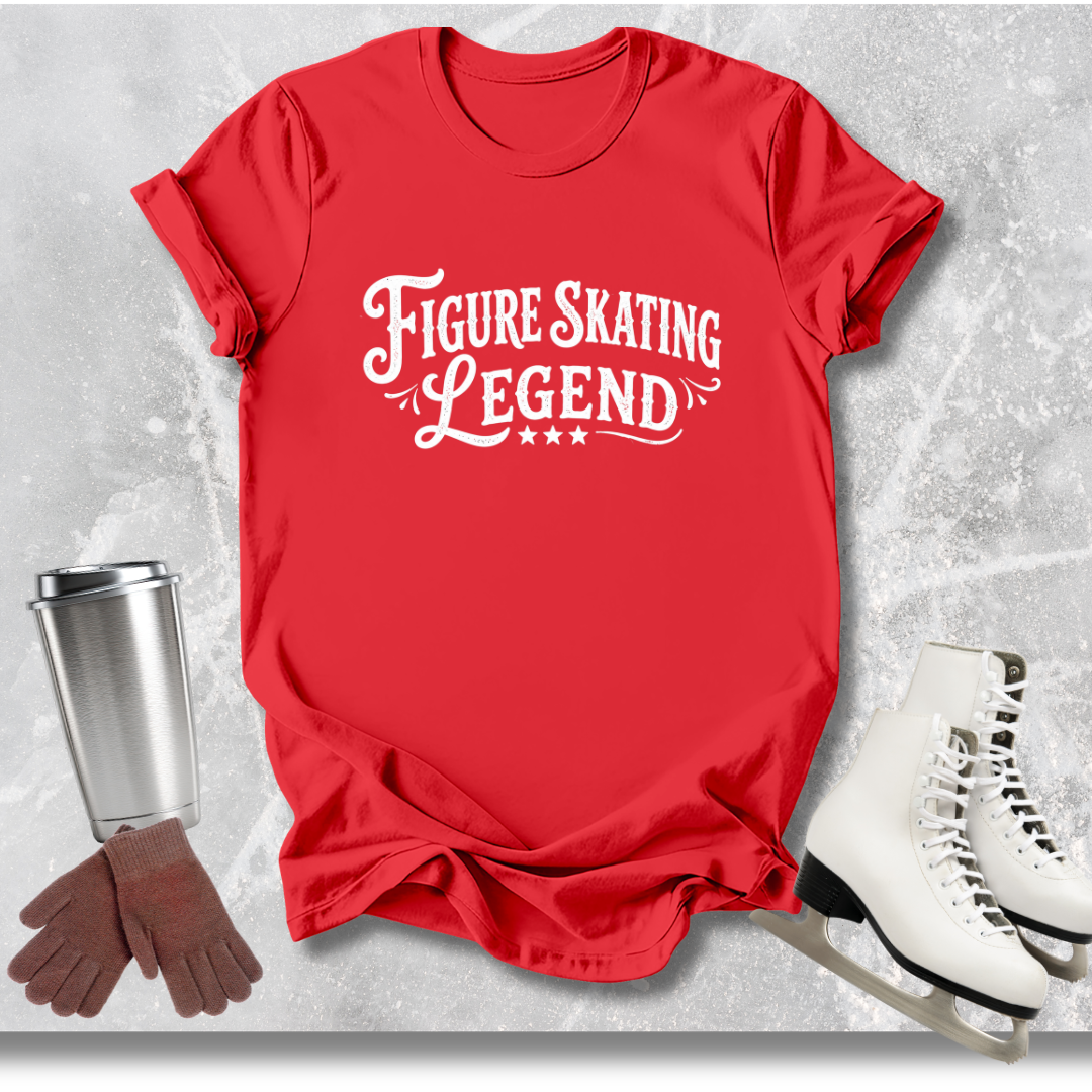 Red t-shirt with 'Figure Skating Legend' text, next to ice skates, gloves, and a cup on a textured gray background.