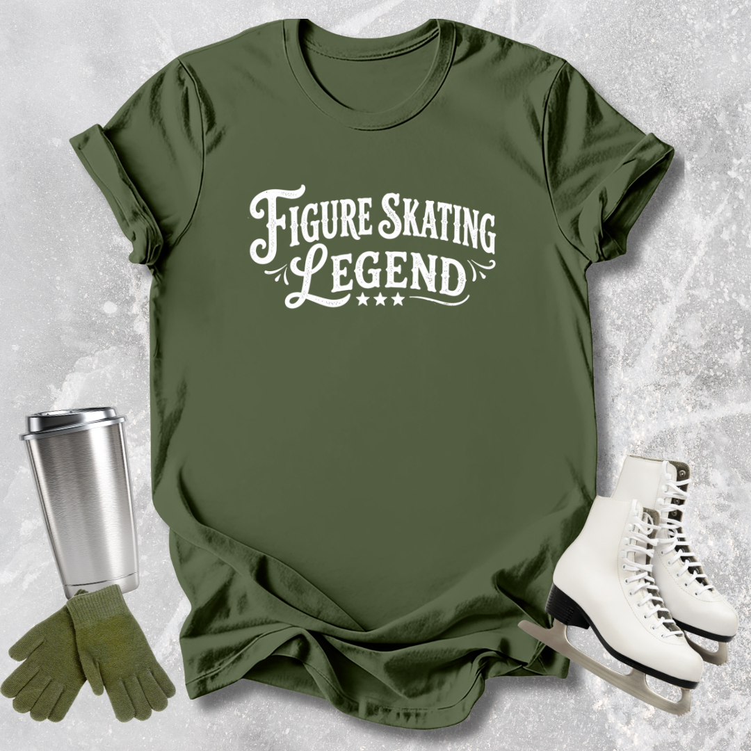 Green t-shirt with 'Figure Skating Legend' text, next to a silver tumbler, green gloves, and white skates on a textured gray background.